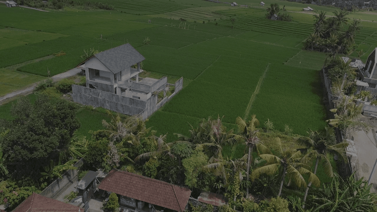Aerial view of a villa surrounded by green rice fields in Bali — Frigate Bali