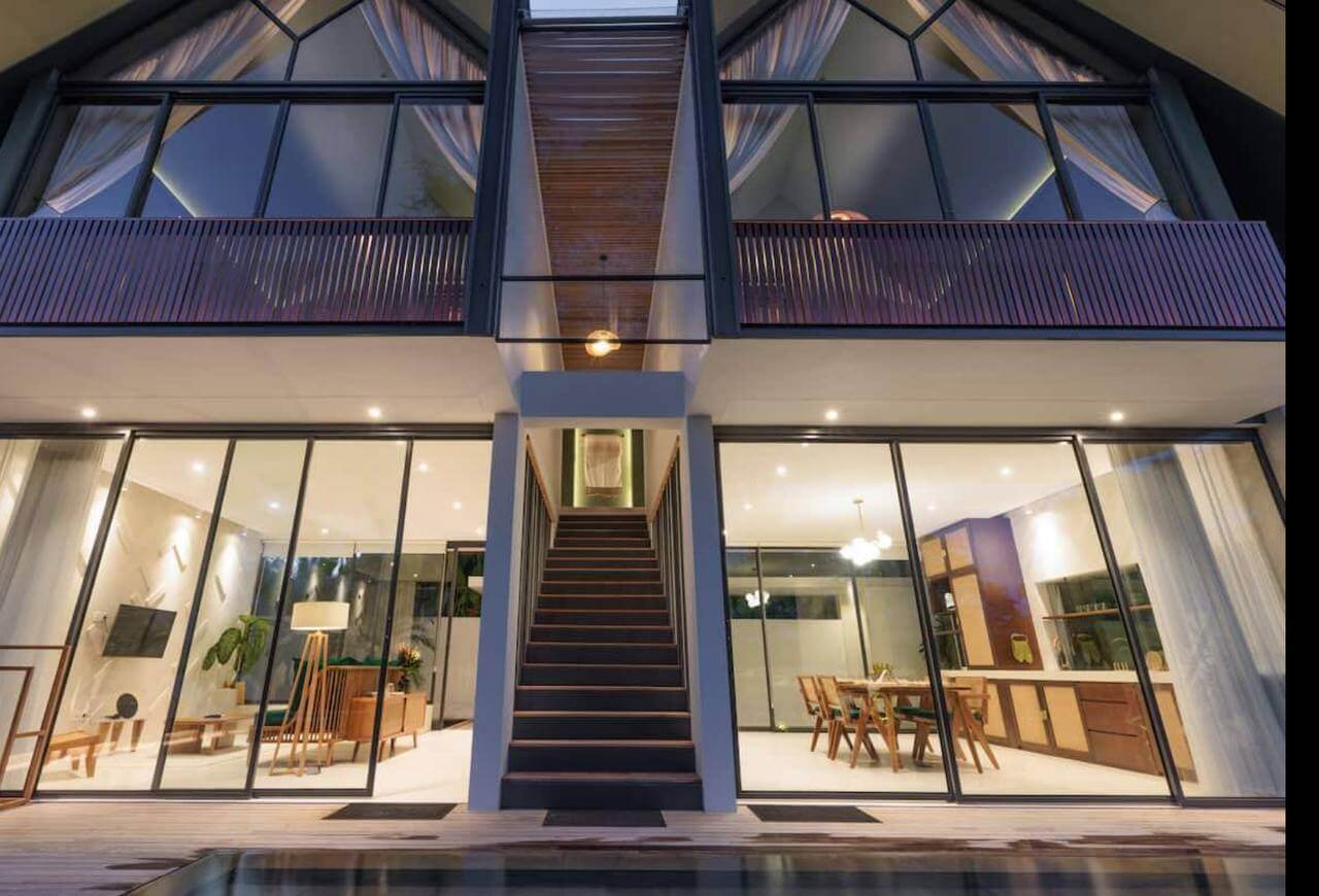 Illuminated villa facade with central staircase at night in Bali — Frigate Bali